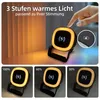 A hand is shown touching a lamp that has a wireless charging symbol on it. The lamp is shown in different brightness levels. Produktbild-Vorschau