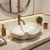 A bathroom countertop with a vessel sink and faucet. Anteprima dell’immagine prodotto