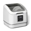A white Klarstein SilentScrub countertop dishwasher is shown against a white background. The dishwasher has a transparent lid, revealing stacked plates inside. A digital touchscreen display is visible on the front. Produktbild-Vorschau