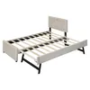 A beige upholstered bed frame with a pull-out trundle bed and a tufted headboard, shown against a white background. Anteprima dell’immagine prodotto