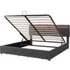 A bed frame with the mattress support system lifted, revealing storage space underneath. The headboard has LED lighting. Voir les images du produit