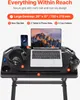 A black foldable laptop table with a laptop, headphones, and a phone on it. Podgląd zdjęcia produktu