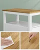 Close-up shots of a white and wooden table, showing water resistance and scratch resistance. Náhled obrázku produktu