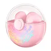 A pair of pink wireless earbuds in a clear, spherical charging case with colorful lighting effects. Náhľad obrázku produktu