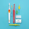 A collection of dental hygiene products, including toothbrushes and interdental brushes, arranged on a blue background. Produktbild-Vorschau