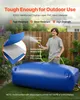 A man is filling a large blue water storage bladder with a hose in a backyard setting. Podgląd zdjęcia produktu