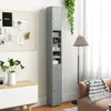 A tall, narrow gray cabinet with shelves and doors is shown in a room setting, next to a bulletin board and a sofa. Podgląd zdjęcia produktu