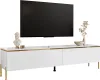A white TV stand with gold accents and legs, featuring a large black television mounted above it. Decorative items, including a bust and a vase with dried flowers, are placed on the stand. Náhled obrázku produktu