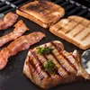 A close-up shot of grilled food items on a grill. Produktbild-Vorschau