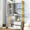 A white and gold bookshelf with various decorative items and books displayed on its shelves. Podgląd zdjęcia produktu