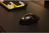 A gaming mouse and keyboard are placed on a dark desk. Produktbild-Vorschau