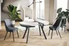 A modern dining room with a round extendable table and two chairs. Voir les images du produit