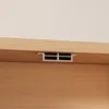A close-up view of a vent on a wooden surface, likely part of furniture. Produktbild-Vorschau