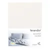 A fitted sheet is shown folded with two pillows and a rumpled sheet in the background. Produktbild-Vorschau