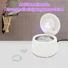 A white ultrasonic cleaner is shown with jewelry next to it, and text overlays describing its function. Produktbild-Vorschau