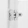 A close-up of a metal latch on a white, textured surface. Podgląd zdjęcia produktu