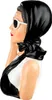 A figurine of a woman in a headscarf and sunglasses. Produktbild-Vorschau