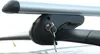 A close-up shot of a car roof rack system, showing the locking mechanism and a key. Náhled obrázku produktu