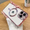 A hand holding a rose gold iPhone case with a MagSafe ring and camera protection. Produktbild-Vorschau