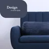 A close-up of a dark blue bolster pillow on a dark blue sofa. Podgląd zdjęcia produktu