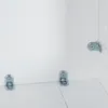 Interior view of a white cabinet or box with metal corner brackets attached to the inside walls and floor. Voir les images du produit
