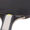 A close-up view of a table tennis racket, showing the rubber and handle. Podgląd zdjęcia produktu