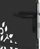 A close-up view of a black metal gate with a decorative floral cutout pattern and a black door handle and lock mechanism. Produktbild-Vorschau
