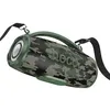 A camouflage-patterned portable speaker with a handle and a strap, shown against a white background. Náhľad obrázku produktu