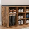 A close-up view of a wooden shoe storage cabinet with a padded bench top. Anteprima dell’immagine prodotto