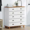 A white dresser with a wooden top and wooden legs, decorated with a vase of flowers and a framed picture on top. Voir les images du produit