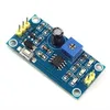 A close-up, high-angle shot of a blue electronic timer module breakout board with various components. Produktbild-Vorschau