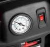 A close-up view of a pressure gauge and a red switch on a black device. Podgląd zdjęcia produktu