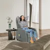 A woman relaxes in a gray massage chair in a living room. Podgląd zdjęcia produktu