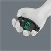 A white mannequin hand holding a black and green tool. Produktbild-Vorschau