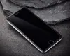 A smartphone with a black screen is placed on a dark, textured surface with rocks in the background. Voir les images du produit