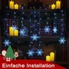 A decorated bookshelf with Christmas lights and decorations. Anteprima dell’immagine prodotto