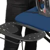 A close-up view of an ironing board with an iron on it, and a person's legs in the background. Produktbild-Vorschau