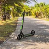 A scooter is parked on a paved path in a park-like setting with palm trees. Náhľad obrázku produktu