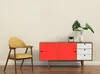 A yellow chair and a red and white cabinet are placed against a cream-colored wall. Podgląd zdjęcia produktu