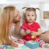 A mother and child are playing with a toy record player. Náhľad obrázku produktu