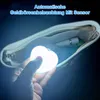 A hand holding a heart-shaped LED light inside a white handbag. Produktbild-Vorschau
