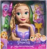The image shows a Disney Princess Rapunzel Deluxe Styling Head toy in its packaging. The packaging displays the product, along with various accessories and promotional text. Náhľad obrázku produktu