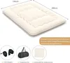 A beige floor mattress with dimensions indicated, along with accessories like straps, a bag, and a cover. Produktbild-Vorschau