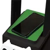 A close-up view of a black gaming locker with a green tray holding a smartphone. Podgląd zdjęcia produktu