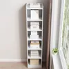 A tall, narrow white bookshelf filled with various boxes and books, placed next to a window with a curtain. Podgląd zdjęcia produktu