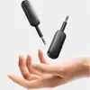 Two black Ugreen Bluetooth receivers are shown floating above an open hand. Anteprima dell’immagine prodotto