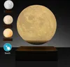 A floating moon lamp with different color options displayed on the side, on a dark background. Produktbild-Vorschau
