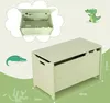 A toy chest with dimensions shown, and a cartoon alligator illustration. Voir les images du produit