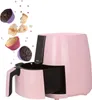 A pink air fryer with cupcakes and cake pieces flying out of it. Anteprima dell’immagine prodotto