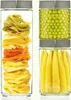 Two glass canisters filled with food items, one with pasta and the other with peas and baby corn. Produktbild-Vorschau